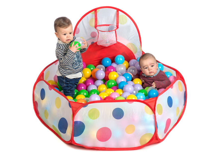 kids playing inside soft play balls pool